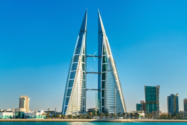 Bahrain World Trade Center towers in Manama skyline against a blue sky, representing travel and Bahrain visa services from Dubai.