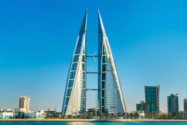 Bahrain World Trade Center towers in Manama skyline against a blue sky, representing travel and Bahrain visa services from Dubai.