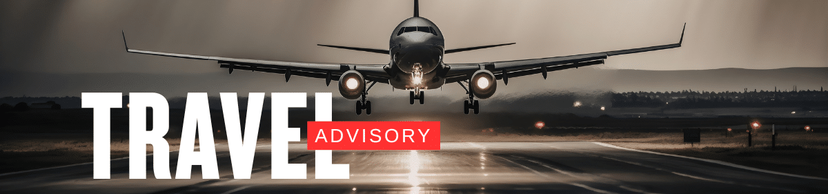 Commercial airplane landing on a runway at dusk with a bold Travel Advisory text overlay for flight updates.