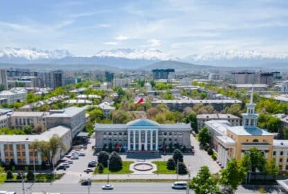 Aerial view of Bishkek City Hall and snow-capped Tian Shan mountains for Kyrgyzstan holiday packages from Dubai, UAE.