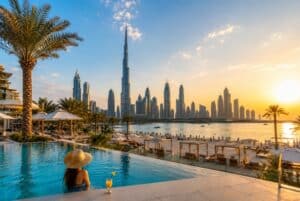 Woman in a resort infinity pool looking at the Burj Khalifa skyline. Is Dubai worth visiting in summer 2026 travel guide.