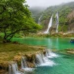 Lush waterfalls and turquoise lagoon in Salalah, Oman during Khareef 2026 travel guide for UAE residents.