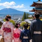 Family in traditional yukata looking at Mount Fuji and a pagoda during a Japan family vacation in summer 2026.