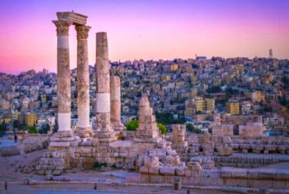 Ancient Temple of Hercules columns at the Amman Citadel overlooking Amman, Jordan at sunset.
