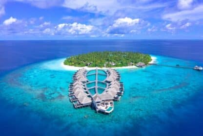 Aerial view of luxury Maldives overwater villas, ideal for Maldives holiday packages from Dubai.
