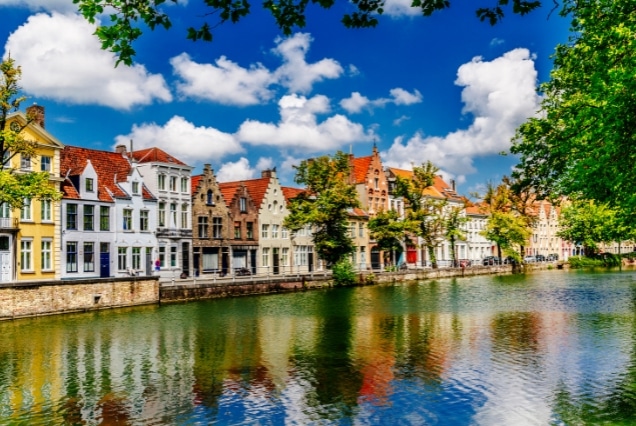 Bruges Belgium canal lined with colorful medieval houses and historic architecture