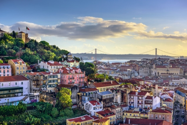 Lisbon Portugal scenic cityscape with colorful rooftops and iconic 25 de Abril Bridge