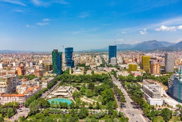 Aerial view of Tirana city centre park and skyline with mountains – Albania Holiday Package