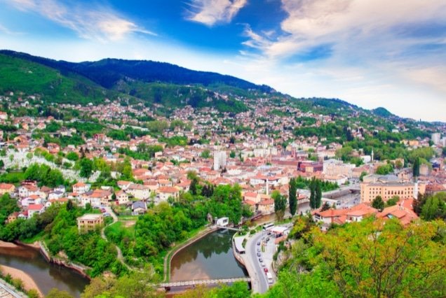 Sarajevo city and Miljacka River with green hills – Bosnia and Herzegovina Tour Package
