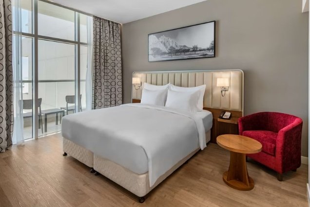 Standard room with large bed and balcony at Radisson Resort Ras Al Khaimah Marjan Island