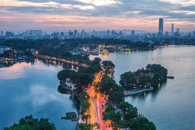 Hanoi skyline and West Lake at dusk with city lights – Vietnam Holiday Package